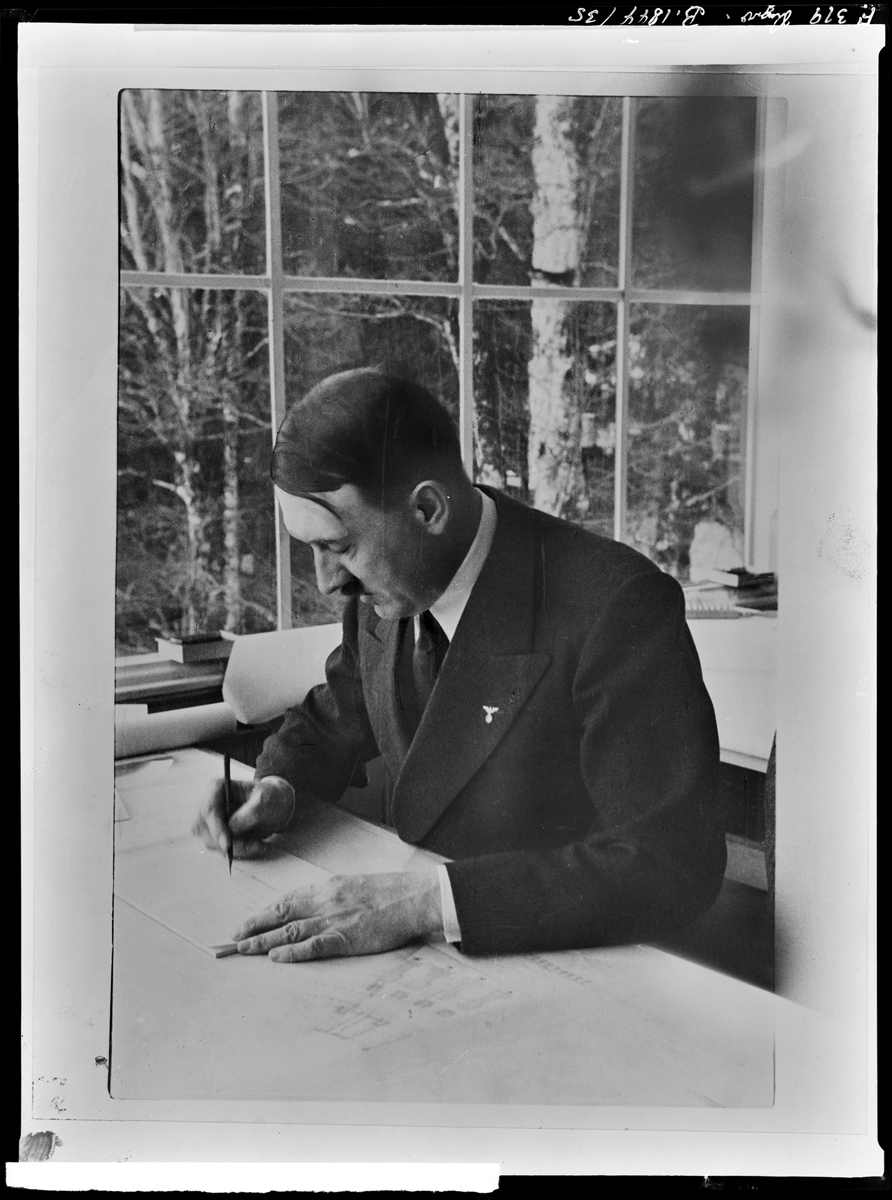 Adolf Hitler working on architectural plans in Bechstein house on the Obersalzberg 
